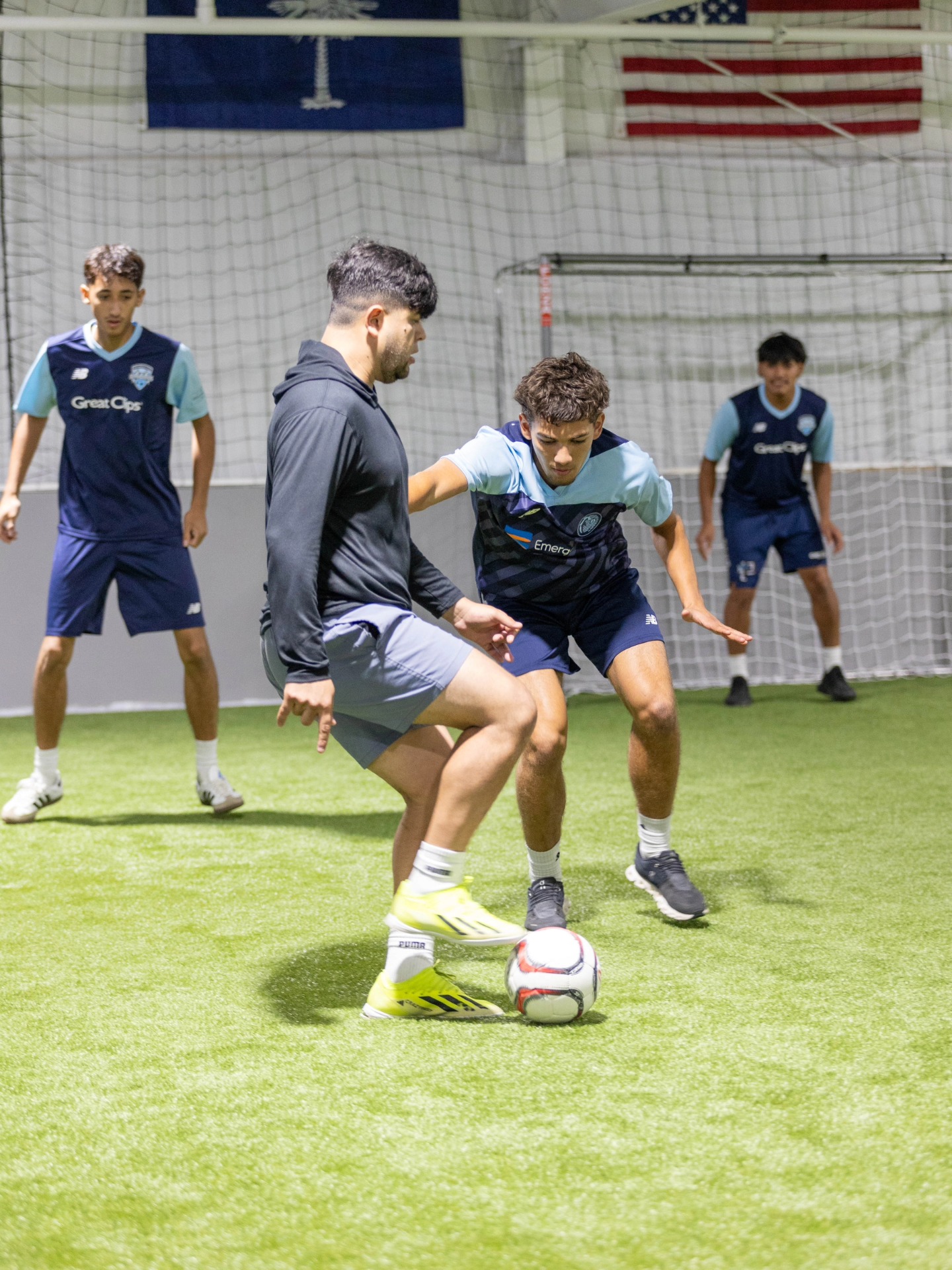 CopaFit coach giving individual instruction to a young soccer player